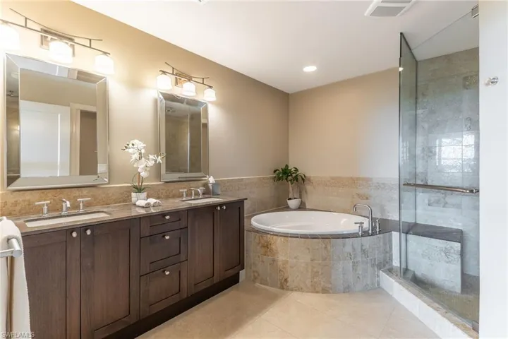 Full bathroom with a garden tub, double vanity, tile patterned flooring, tiled shower, and recessed lighting