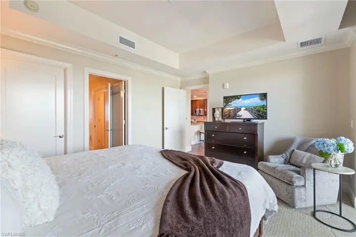 Bedroom featuring crown molding and a tray ceiling