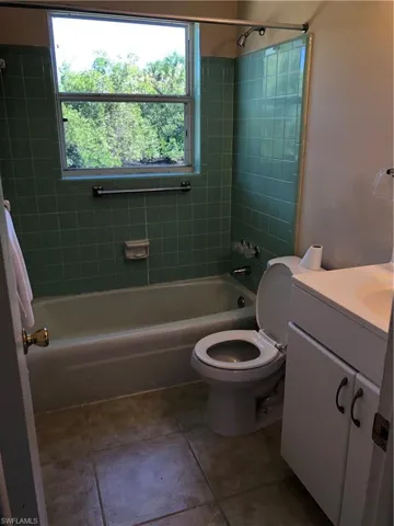 Full bathroom featuring tile floors, tiled shower / bath
