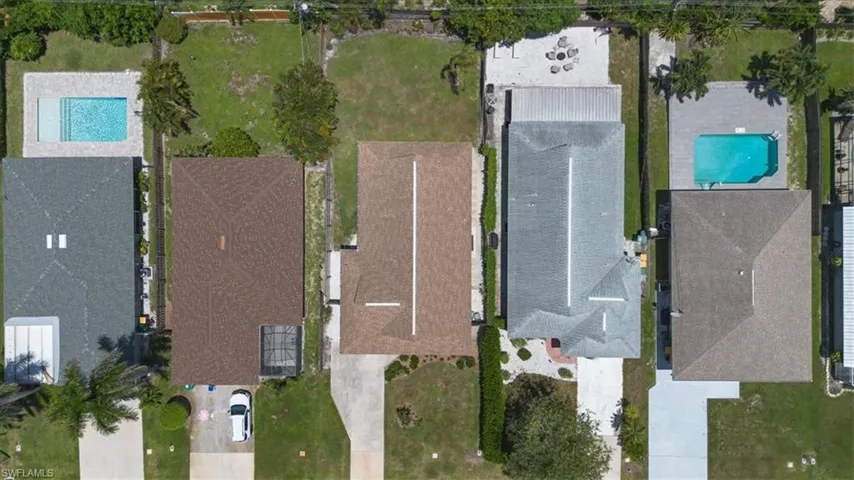Aerial view of property and surrounding area with a pool