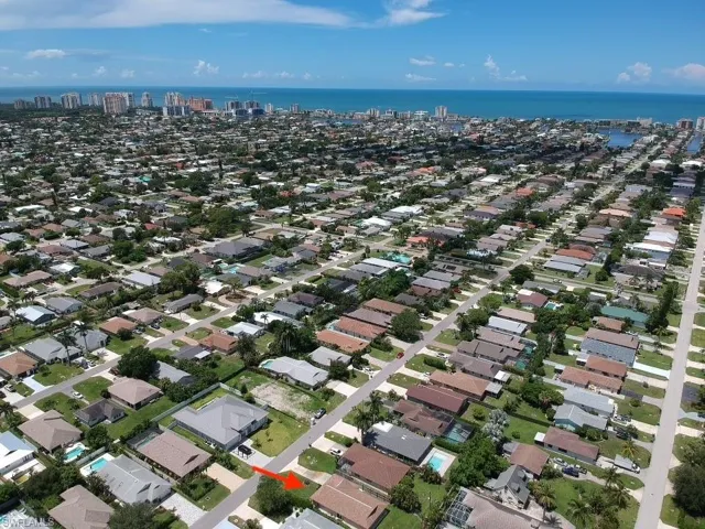 Aerial overview of property's location featuring nearby urban area and a nearby body of water