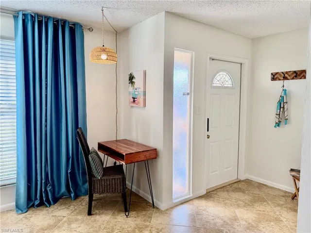 Foyer with a textured ceiling