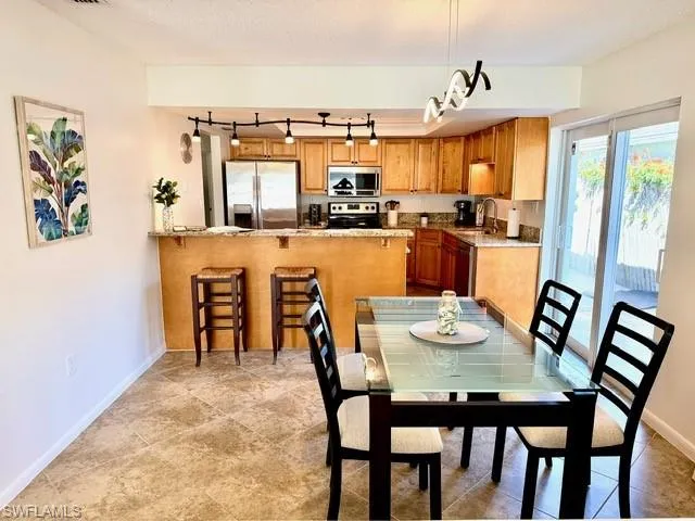Dining space featuring rail lighting and a textured ceiling