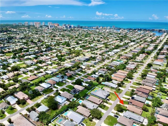 Aerial view of residential area featuring a large body of water