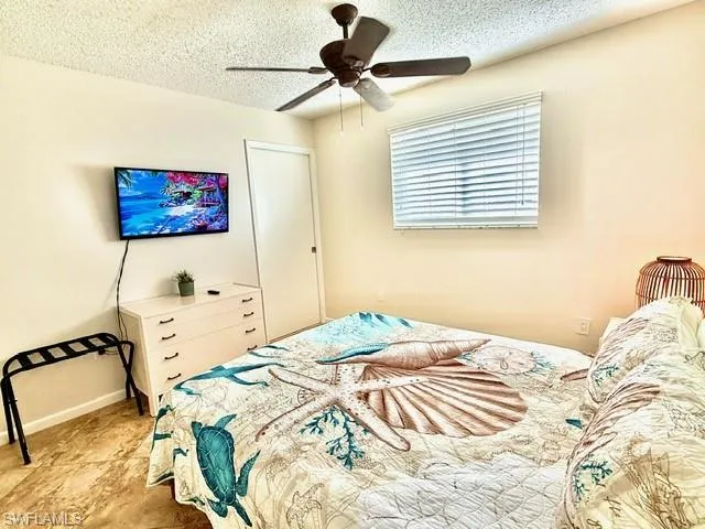 Bedroom featuring a textured ceiling and ceiling fan