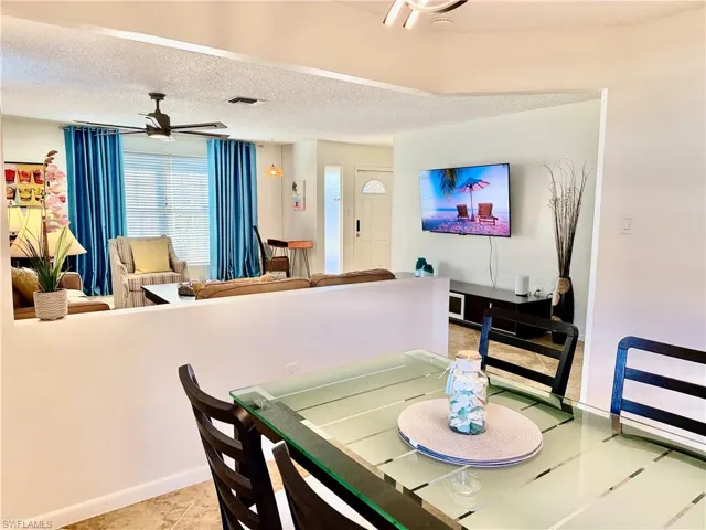 Dining room with a ceiling fan and a textured ceiling