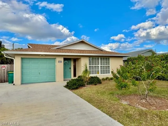 Ranch-style home featuring driveway, stucco siding, a shingled roof, and an attached garage