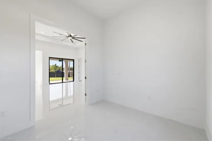 Spare room featuring a ceiling fan and light tile patterned floors