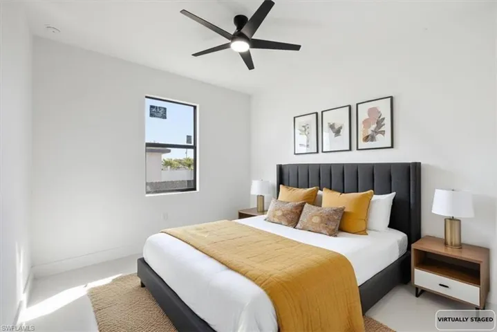 Bedroom with a ceiling fan and baseboards