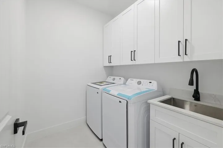 Laundry area with washing machine and clothes dryer and cabinet space