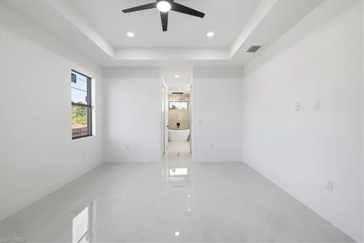 Spare room featuring recessed lighting, a tray ceiling, and ceiling fan