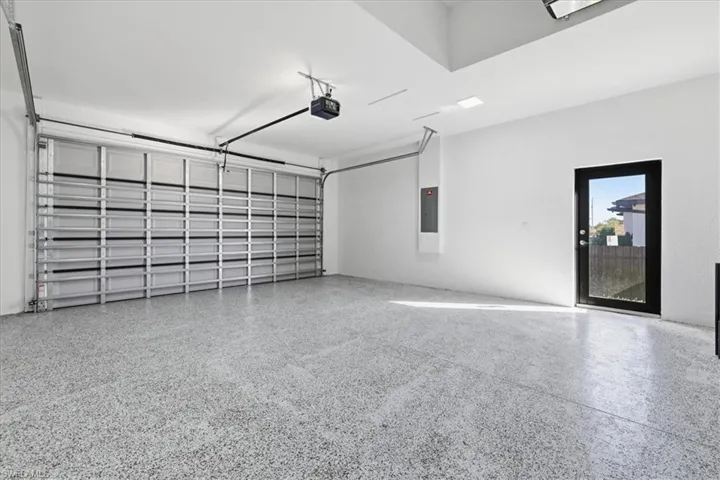 Garage with a garage door opener and electric panel
