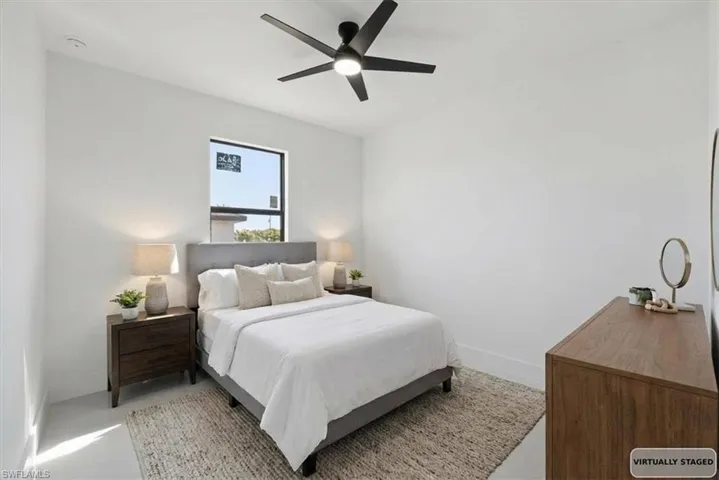 Bedroom featuring ceiling fan and baseboards