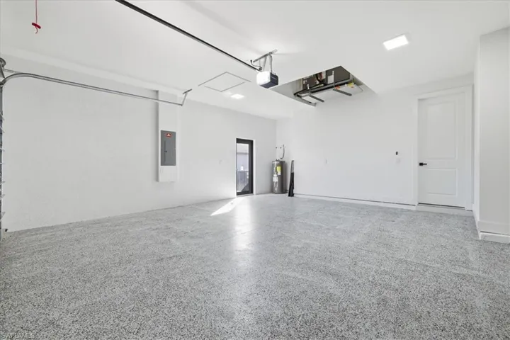 Garage with water heater and electric panel