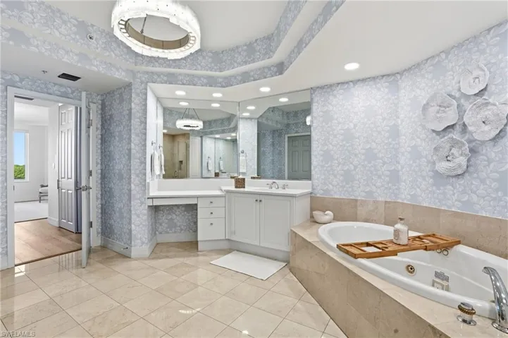 The Master Bathroom boasts a Stunning Chandelier and Jacuzzi Tub.