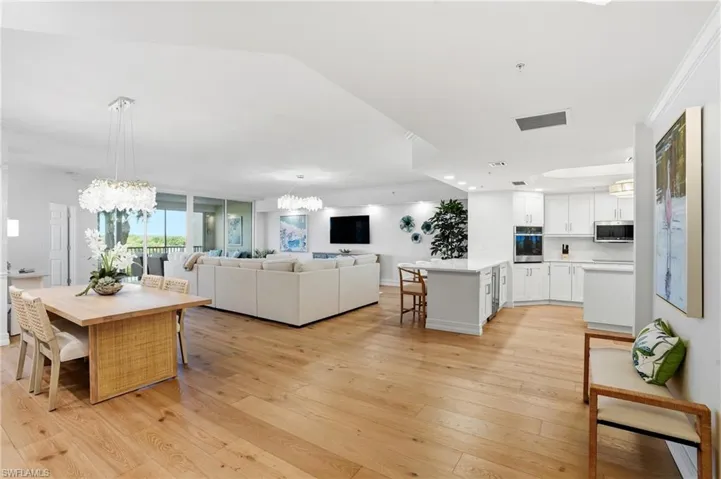 View upon entry. Spacious, open-concept living, dining, and kitchen area.