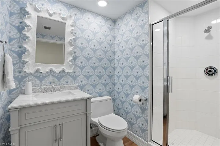 Bathroom #2 Features Coastal Accents and a Walk-In Shower.