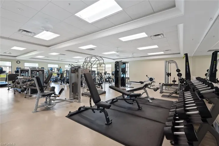 Workout area featuring beamed ceiling, coffered ceiling, and a paneled ceiling