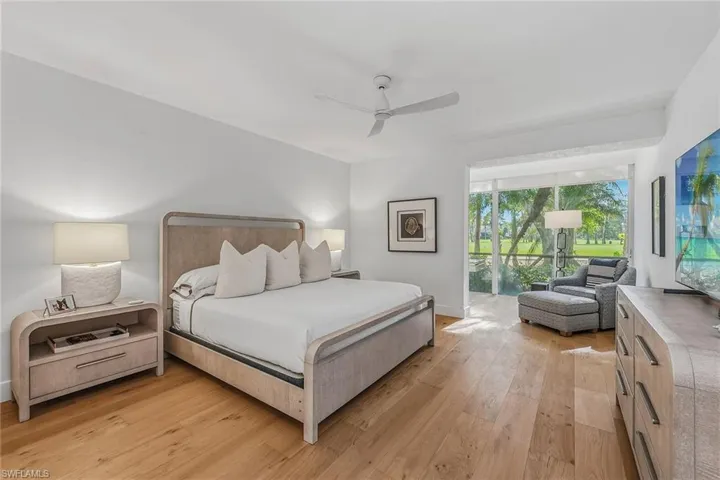 Bedroom with light wood finished floors, ceiling fan, and access to exterior