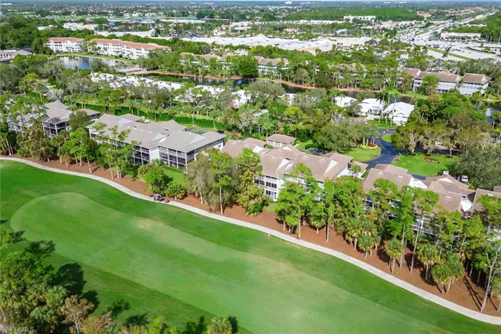Aerial overview of property's location with a local golf course, a large body of water, and nearby suburban area