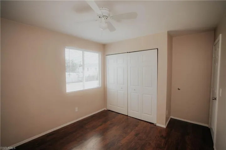 Washer hook-up in a dedicated utility space featuring tan wall paint, tiled flooring, and wall-mounted shelving
