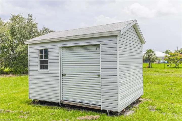 View of outbuilding with a yard