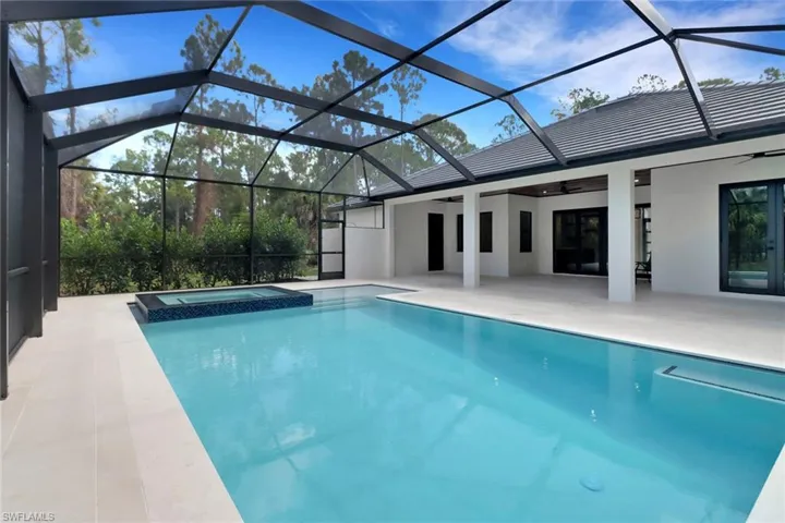 View of pool featuring a lanai, a patio area, an in ground hot tub, and ceiling fan