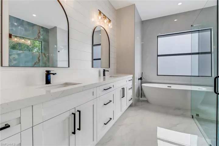 Bathroom featuring vanity and shower with separate bathtub