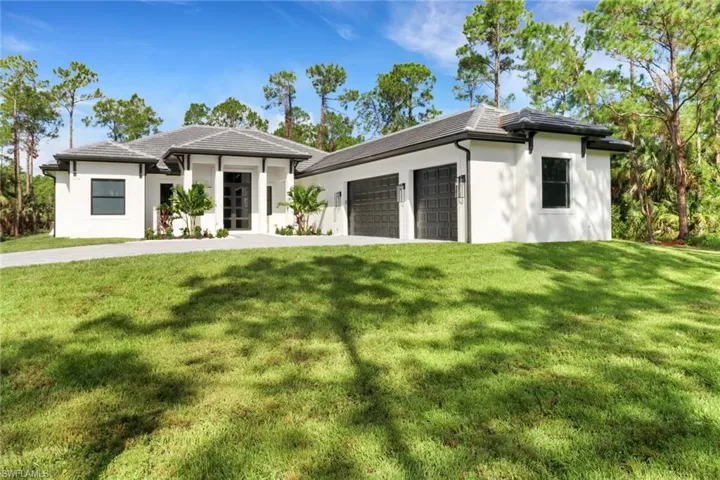 Prairie-style home featuring a garage and a front yard