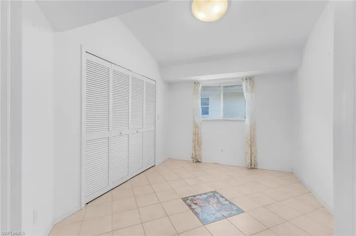 Unfurnished bedroom with light tile patterned floors and a closet