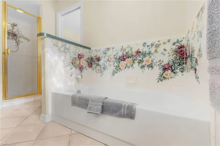 Bathroom with tile patterned flooring and a shower with shower door