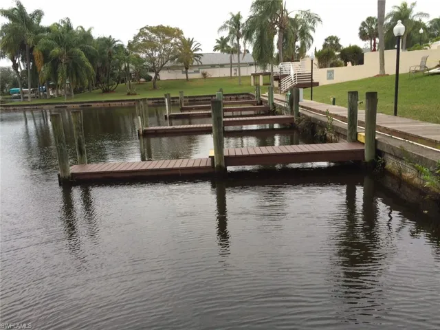 Dock area featuring a water view and a yard