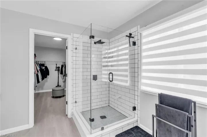 Bathroom featuring hardwood / wood-style floors and walk in shower