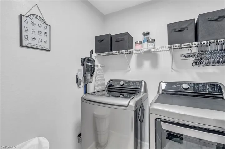 Clothes washing area featuring washing machine and clothes dryer