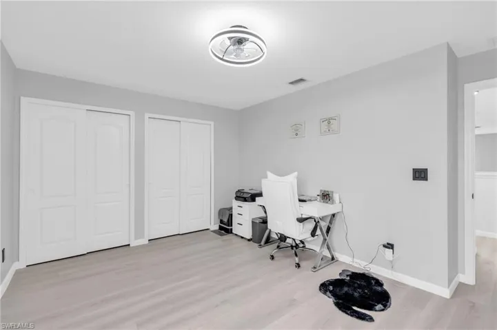 Home office with light hardwood / wood-style floors