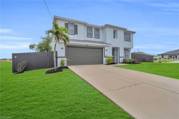 View of front of home featuring a garage and a front yard