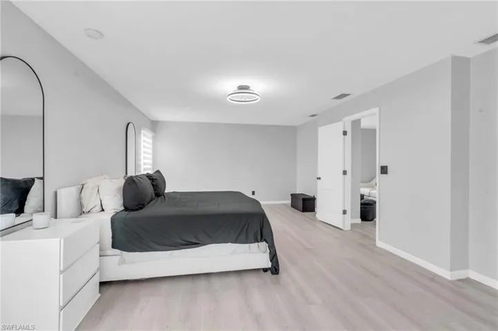 Bedroom with light hardwood / wood-style floors