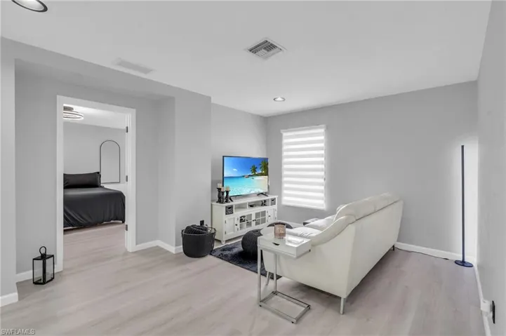 Living room with light hardwood / wood-style flooring