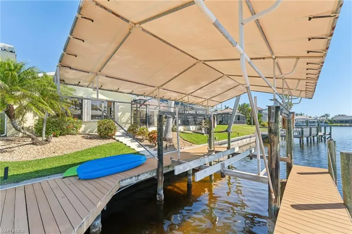 Dock area with a water view and boat lift