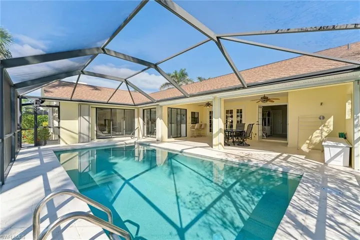 Outdoor pool with a patio, a lanai, and a ceiling fan