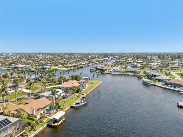 Birds eye view of property with a water view and a residential view