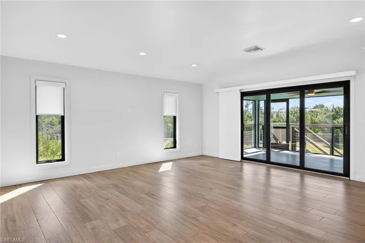 Bright, spacious living area with exceptional cross breeze when front and back porch doors are open.