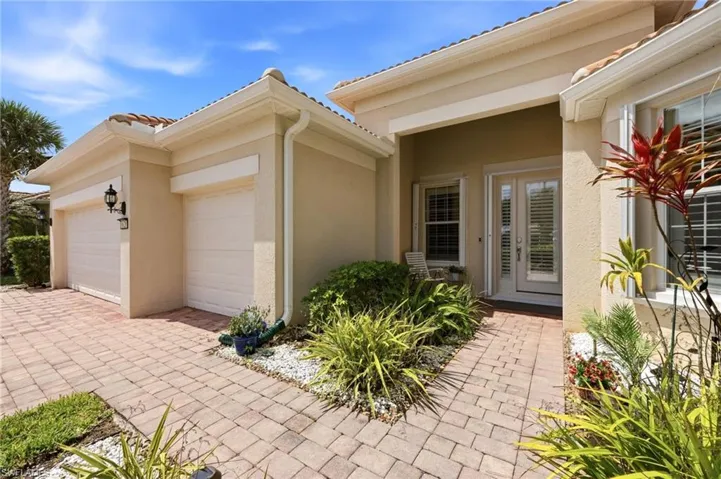 Covered entrance with accordion storm shutters