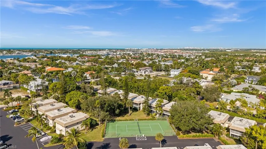 Aerial perspective of suburban area with a nearby body of water