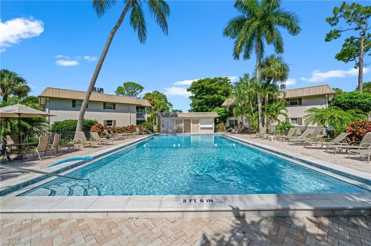 Community pool with a patio