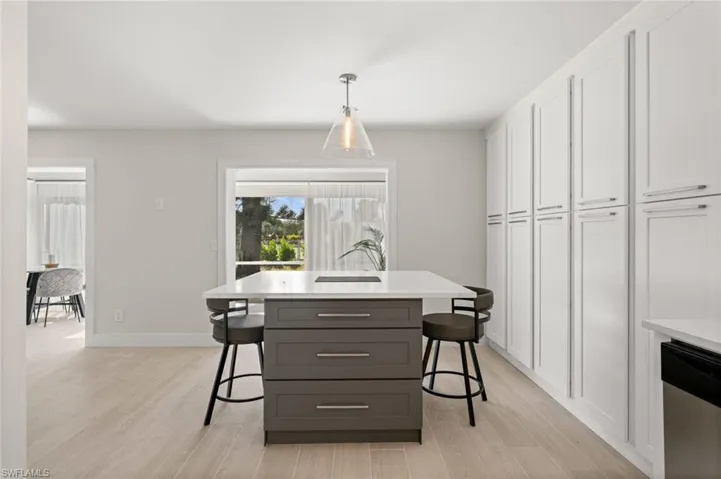 Dining room with light wood-style flooring and baseboards