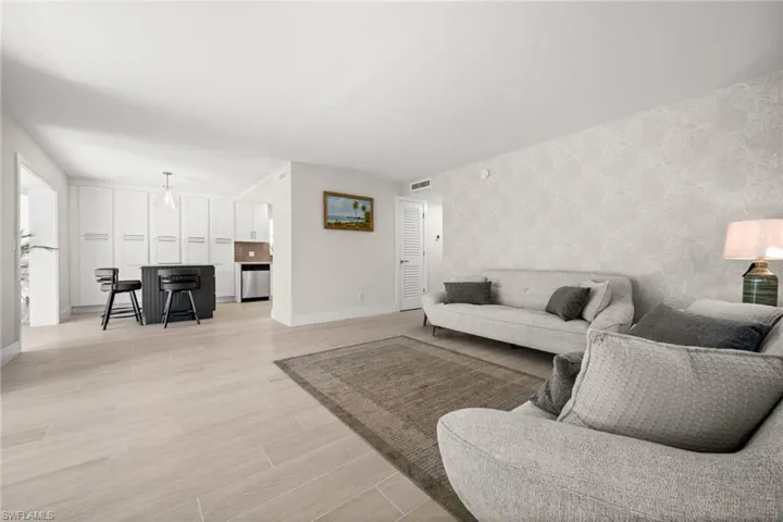 Living room featuring light wood-type flooring and wallpapered walls