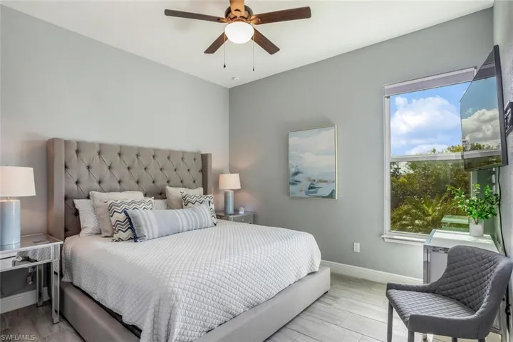 Bedroom featuring ceiling fan and wood tiled floors