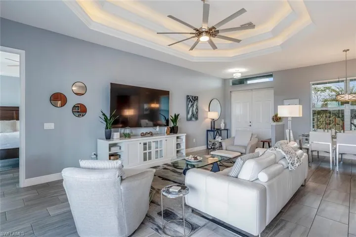 Living room featuring a ceiling fan and baseboards