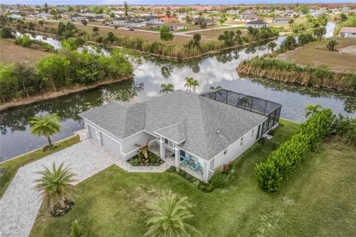 Aerial perspective of suburban area featuring a nearby body of water